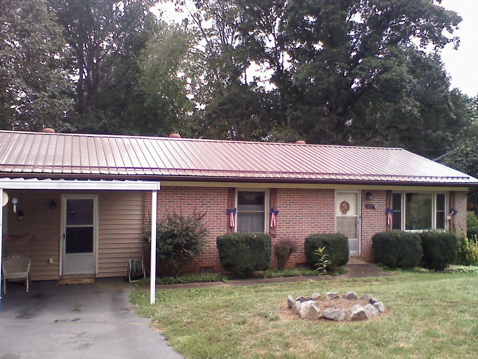 Bronze metal roof and carport on a brick ranch home — Roof Repair work by our crew in Breinigsville